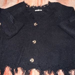 black sweater with brown buttons